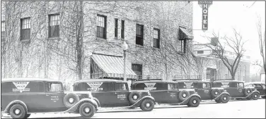  ?? Courtesy photo ?? Harris Bakery trucks lined up in about 1940 on Second Street beside the Harris Hotel in Rogers. In 1927, at the age of 30, Earl Harris came back to Northwest Arkansas and opened the little bakery at 107 W. Walnut St., Rogers, with the help of his...