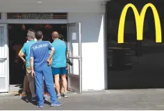  ??  ?? ATHLETES LINE UP at a McDonald’s inside the Olympic village in Rio de Janeiro, Brazil on Aug. 1, 2016.