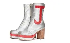  ?? ?? This handout picture shows a pair of silver leather tall platform boots, circa 1971, part of a selection of fashion pieces from Elton John’s dazzling stage wardrobe.