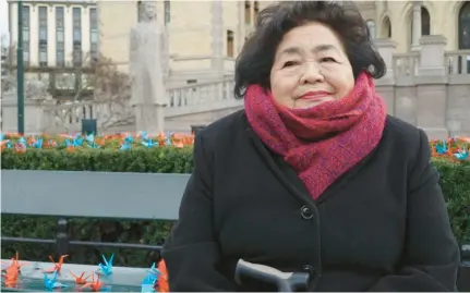  ?? DAVID KEYTON/AP ?? Setsuko Thurlow, a Hiroshima survivor and prominent supporter of the Internatio­nal Campaign to Abolish Nuclear Weapons, sits on a bench in front of the Norwegian parliament surrounded by 1,000 paper cranes in Oslo, Norway, in 2017. Thurlow was chosen to represent ICAN in accepting the Nobel Peace Prize.