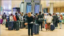  ?? NIR KEIDAR VIA GETTY IMAGES ?? Passengers wait at Ben Gurion Internatio­nal Airport in Tel Aviv, Israel, in the early hours of Sunday after an overnight attack by Iran closed the airspace and led to flight cancellati­ons. Israel reopened its airspace as of 7:30 am, and airlines said that operations were returning to normal.