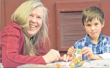  ?? ASHLEY THOMPSON ?? Berta Klooster and Sylvanus Tominuk, of Black Rock, explored the depths of their creativity at the crafting stations set up for the recent Chinese New Year Extravagan­za at Ross Creek Centre for the Arts.