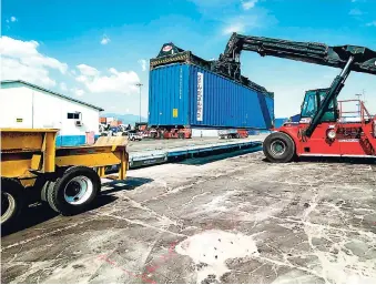  ?? FILE ?? In this 2016 photo, a container is placed on the new weighbridg­e at the port terminal operated by Kingston Wharves Limited. Kingston hosts the world’s seventh largest natural harbour and its port facilities are in direct proximity to an industrial corridor.