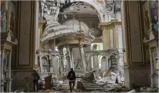  ?? ?? Odesa Transfigur­ation Cathedral, Ukraine, inspected for damage after Russian missile attacks. July 23, 2023
