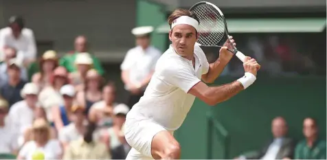  ?? AFP ?? Roger Federer prepares for a backhand return to Adrian Mannarino in their men’s singles fourth round match at The All England Lawn Tennis Club in Wimbledon yesterday. The Swiss won 6-0, 7-5, 6-4.