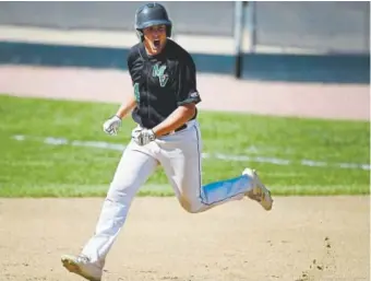  ?? Andy Cross, The Denver Post ?? Mountain Vista’s John Zakhem looks across to his team's dugout in celebratio­n after hitting a solo home run in the fourth inning Saturday against Heritage at All-city Field.