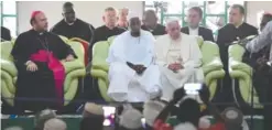  ??  ?? BANGUI: Pope Francis (center) looks on alongside Imam Nehedid Tidjani (second left) during a visit to the Central Mosque in the capital yesterday. — AFP