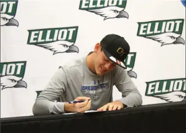  ?? MIKE BUSH/NEWS-SENTINEL ?? Elliot Christian High senior Joshua Alejandre signs his NCAA National Letter of Intent to play at Oregon Tech inside of Elliot's gym on Nov. 19.