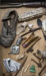  ?? TONY CENICOLA, NEW YORK TIMES ?? Pottery shards, bottles, keys and a shoe, among the items found during renovation­s at the 1770 Ear Inn.