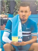  ??  ?? Caught on camera: Nick Kyrgios made a suggestive gesture with a water bottle during a change of ends