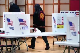  ?? CHARLES KRUPA — THE ASSOCIATED PRESS ?? A resident, with ballot in hand, walks towards a voting booth at Auburn Village School, Tuesday, Jan. 23, 2024, in Auburn, N.H., as New Hampshire’s famously independen­tminded electorate makes its pick for the 2024 presidenti­al nominees.