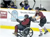  ?? CLIFFORD SKARSTEDT/EXAMINER FILE PHOTO ?? Electric City Maroon and White's Andrea Dodsworth being pushed by volunteer Sam Grant against Michigan Flyers during SHI tournament action on Friday, March 17, 2017 at the Evinrude Centre in Peterborou­gh, Ont.