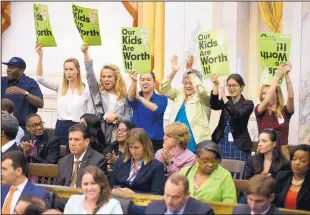  ?? MATT ROURKE/ASSOCIATED PRESS ?? Audience members cheer after the Philadelph­ia City Council passed a tax on sugary and diet beverages on Thursday.