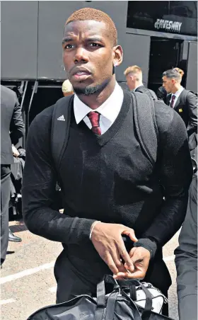  ??  ?? Taking off: Paul Pogba arrives at Manchester Airport with the United squad