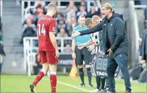  ?? LINDSEY PARNABY/AFP ?? Liverpool manager Jurgen Klopp gestures to midfielder Jordan Henderson during their English Premier League match against Newcastle on Sunday.