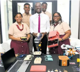  ?? ASHLEY ANGUIN/PHOTOGRAPH­ER ?? Herbert Morrison Technical High engineerin­g club’s (back row, left to right): Ryan Gooden, Javey Heaven, (front row, left to right) Prudent Salmon, Kevin Coke, mechanical technology teacher, and Kayla Hewan pose for The Gleaner on Day Two yesterday during the Jamaica Teachers’ Associatio­n 60th Anniversar­y Education Conference at Ocean Coral Spring in Trelawny.