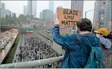  ?? aP-erika schultz ?? Crowds demonstrat­e against police brutality on I-5 in Seattle on Saturday. Protests continue across the country over the death of George Floyd, a black man who died after being restrained by Minneapoli­s police officers on May 25.