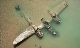  ?? Photograph: Joseph Mearman/SCSEE/Bangor University ?? The Lockheed P-38 Lightning, nicknamed the Maid of Harlech, is sometimes visible in the sand.