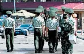  ?? GREG BAKER/GETTY-AFP ?? Chinese paramilita­ry police march to the Beijing airport Wednesday to prepare for the departure of Kim Jong Un.