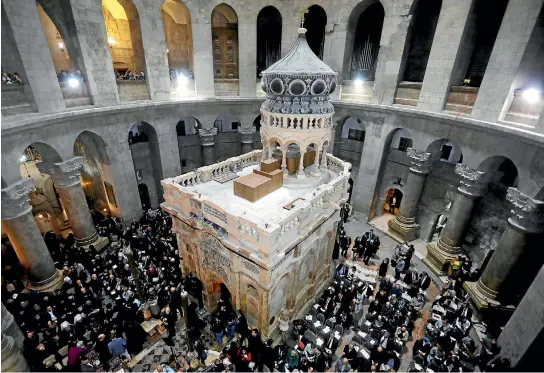  ?? PHOTOS: REUTERS ?? Christian clergymen and other guests attend a ceremony marking the end of restoratio­n work on the site of Jesus’s tomb, in the Church of the Holy Sepulchre, in Jerusalem’s Old City.