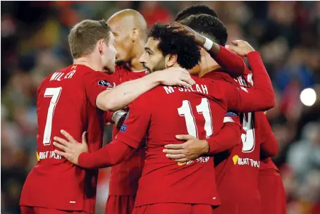  ?? Reuters ?? Liverpool’s players celebrate their fourth goal during their Champions League match against Salzburg in Liverpool on Wednesday.
