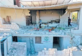  ?? OMAR HAJ KADOUR/GETTY-AFP ?? A building sheltering the only medical center in Syria’s northweste­rn Jabal az-zawiya region was struck by pre-dawn shelling Wednesday. A woman living in the same building was killed in the attack, the latest in a series by government forces on health facilities in areas controlled by rebel and jihadi groups opposed to the regime.