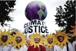  ??  ?? MANILA: Protesters attend a climate change march on a highway in Manila yesterday. Thousands turned out for climate change marches in Manila and Brisbane yesterday, part of a weekend of action across the globe to demand results from next week’s...