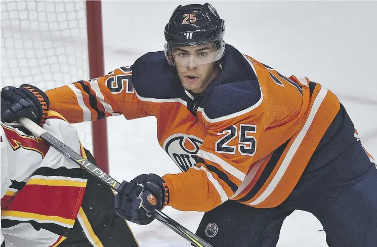  ?? ED KAISER ?? Edmonton Oilers defenceman Darnell Nurse fends off a Calgary Flames’ attacker during Wednesday’s opening-night 3-0 win at Rogers Place.