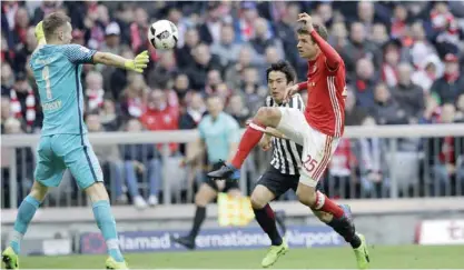  ?? — AP ?? MUNICH: Bayern’s Thomas Mueller, right, tries to score in front of Frankfurt goalkeeper Lukas Hradecky during the German Bundesliga soccer match between FC Bayern Munich and Eintracht Frankfurt at the Allianz Arena stadium in Munich, Germany, yesterday.