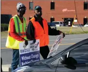  ?? AP-JAY Reeves ?? Tray Ragland, left, and Kim Hickerson of the Retail, Wholesale and Department Store Union hold signs outside an Amazon facility where labor is trying to organize workers on Feb. 9. For Amazon, a successful effort could motivate other workers to organize. But a contract could take years, and Amazon has a history of crushing labor organizing.