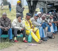  ??  ?? GOING HOME: Striking miner Thaba Poshodi heads for Maseru, Lesotho NO WORK, NO PAY: Platinum miners, on strike for more than three months, faced the prospect of a bleak Easter break