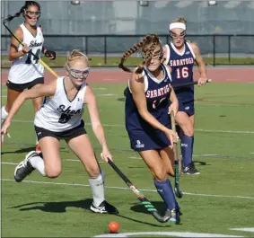  ?? STAN HUDY/THE SARATOGIAN ?? Saratoga Springs midfielder Riley Jameson brings the ball up the field challenged by Shenendeho­wa forward Hannah Merritt Monday in Suburban Council action.