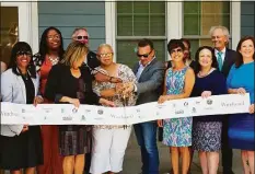  ?? ?? City, state officials, developers and tenants cut the ribbon for the Windward Apartments on Friday.