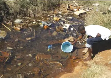  ??  ?? Residents of Mabvuku fetch water from unprotecte­d sources in Harare in 2012. Reuters