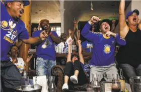  ?? Gabrielle Lurie / The Chronicle ?? Fans at Era Bar and Lounge in Oakland whoop it up for their Warriors during the title-clinching Game 5 win over the Cavaliers.