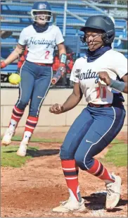  ?? Michelle Petteys, Heritage Snapshots ?? Bailey Christol celebrates as Gracie Dawson sprints home from third on a wild pitch. Dawson’s run was the only score of the game and came in the bottom of the seventh inning as Heritage got by Central-Carroll, 1-0, in Game 1 of their best-of-three series last week. The Generals took the series, two games to one, in a battle between two of the top three ranked teams in Class AAAA.