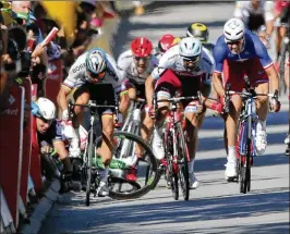  ?? AP ?? Mark Cavendish (left, on ground) crashes after trying to squeeze by Peter Sagan (left rider) late in Tuesday’s fourth stage. Cavendish suffered a fractured right scapula.