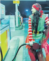  ??  ?? ●● Roxy (above) filling up her car at the local petrol station and (below) meeting a reindeer