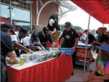  ?? SUSAN L. SERBIN — DIGITAL FIRST MEDIA ?? The Hoagies for Heroes competitio­n on opening day at the new Media Wawa pits Media Police Department vs, Riddley Health Care Services EMS. Lt. Rick Johnson at right leads his staff.