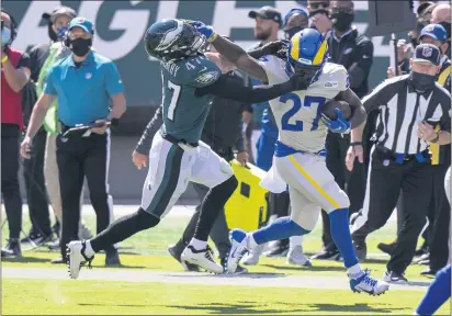  ?? CHRIS SZAGOLA — THE ASSOCIATED PRESS ?? Eagles linebacker Nate Gerry, left, gets stiff-armed by Rams running back Darrell Henderson during their game on Sept. 20.