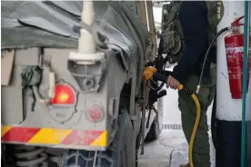  ?? Photograph: Alexi J Rosenfeld/Getty Images ?? An IDF soldier fills a Hummer with gas at a station near the Gaza border in southern Israel, on 19 November 2023.