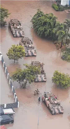  ??  ?? WET WARRIORS: Army vehicles are used to evacuate residents during the height of the flooding.