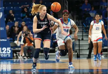  ?? Associated Press ?? Foot race: UConn forward Dorka Juhasz, left, and DePaul forward Aneesah Morrow chase a loose ball during the second half Saturday in Chicago.