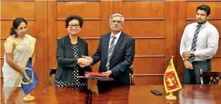  ??  ?? From left: ADB Sri Lanka Resident Mission Country Director Sri Widowati and Finance and Mass Media Ministry Secretary Dr. R.H.S. Samarathun­ga exchange the signed grant agreement