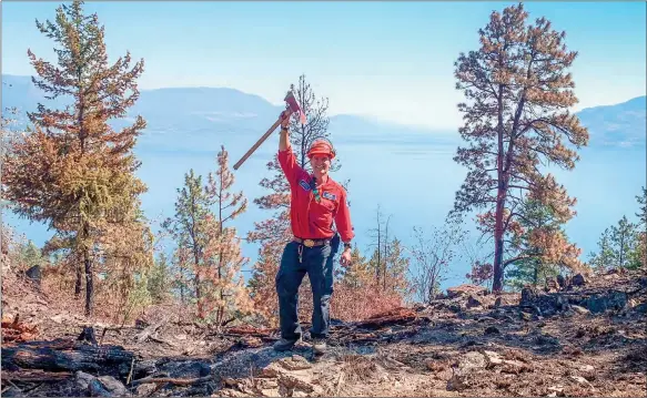  ?? ?? Special to the Herald
Penticton’s Mitch Taylor raises his axe in celebratio­n of another job well done with the BC Wildfire Service.