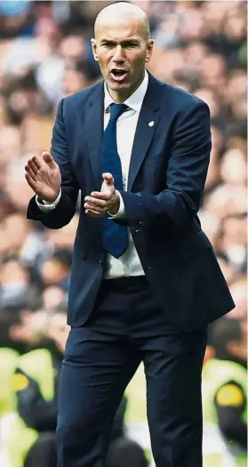  ??  ?? Come on, boys: Real Madrid coach Zinedine Zidane encouragin­g his players in the La Liga match against Espanyol on Saturday. Real won 2- 0. — Reuters