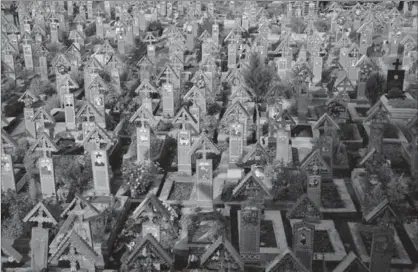  ?? VADIM GHIRDA, THE ASSOCIATED PRESS ?? The Merry Cemetery is a collection of more than 1,000 vivid Orthodox crosses etched with colourful epitaphs and childlike drawings and, despite its remote location some 600 kilometres northwest of the Romanian capital, Bucharest, it’s one of the...