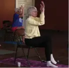  ??  ?? Participan­ts in the yoga class work from chairs during a session.