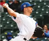  ?? AP (ABOVE), GETTY IMAGES ?? Zach Davies (above), who allowed four runs in four innings Friday, has a 10.32 ERA after three starts. Anthony Rizzo (right), reacting after striking out in the third inning, is hitting .182.