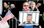  ?? ?? Anti-Trump demonstrat­ors protest outside the Manhattan District Attorney's office in New York City. Trump is expected to be indicted over hush money paid to a porn actress, with Trump calling for mass demonstrat­ions if he is charged. (AFP)